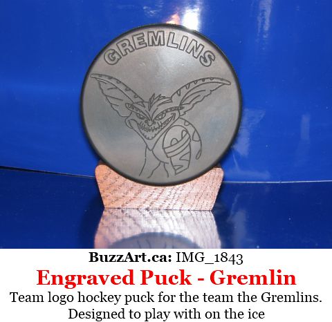 Hockey puck with team Gremlins logo on it